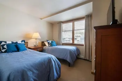 a bedroom with two beds and a window at Zephyr Mountain Lodge Value-Rated 2508 in Winter Park