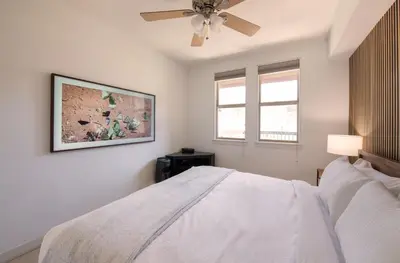 a bedroom with a white bed and a ceiling fan at Winter Park FF Premium-Rated 4564 in Winter Park