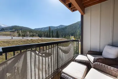 a balcony with two chairs and a view of a mountain at Winter Park FF Premium-Rated 4564 in Winter Park