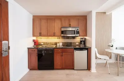 a kitchen with wooden cabinets and a black appliance at Winter Park FF Premium-Rated 4564 in Winter Park