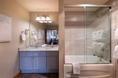 a bathroom with a shower and a tub and a sink at Zephyr Mountain Lodge Select-Rated 2510 in Winter Park