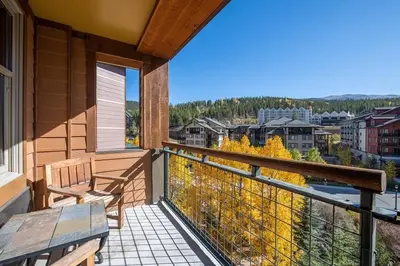 a balcony with a bench and a view of a city at Zephyr Mountain Lodge Select-Rated 2510 in Winter Park
