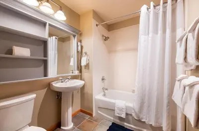 a bathroom with a sink and a toilet and a tub at Zephyr Mountain Lodge Select-Rated 2510 in Winter Park