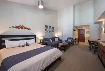a bedroom with a large bed and a living room at Winter Park FF Premium-Rated 4669 in Winter Park