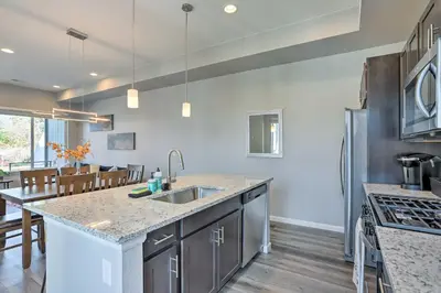 a kitchen with a sink and a counter top at 6 Mi to Dtwn Denver Townhome with Patio! in Thornton