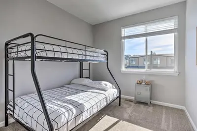 a bedroom with a bunk bed and a window at 6 Mi to Dtwn Denver Townhome with Patio! in Thornton