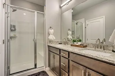 a bathroom with two sinks and a shower at 6 Mi to Dtwn Denver Townhome with Patio! in Thornton