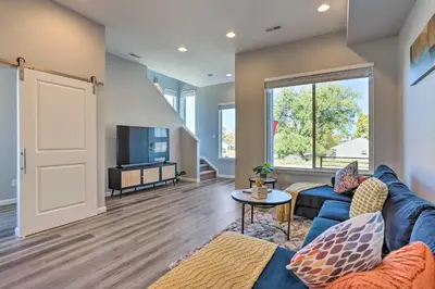 a living room with a blue couch and a tv at 6 Mi to Dtwn Denver Townhome with Patio! in Thornton