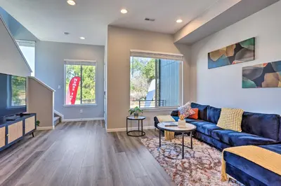 a living room with a couch and a tv at 6 Mi to Dtwn Denver Townhome with Patio! in Thornton