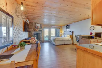a living room with a bedroom and a bed at Near Skiing Studio with Pool Access in Granby! in Granby