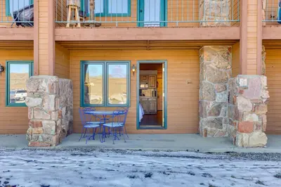 a table and chairs in front of a house at Near Skiing Studio with Pool Access in Granby! in Granby