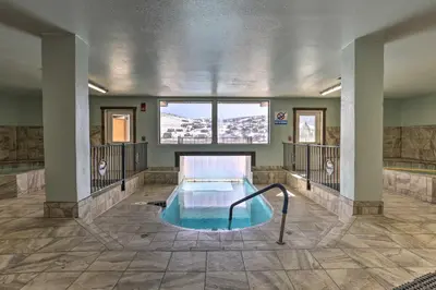 a swimming pool in the middle of a building at Near Skiing Studio with Pool Access in Granby! in Granby