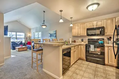 a kitchen with wooden cabinets and a kitchen island at Spacious Fraser Condo about 6 Mi to Winter Park! in Fraser