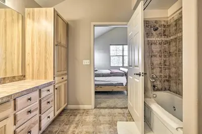 a bathroom with a walk in shower and a tub at Spacious Fraser Condo about 6 Mi to Winter Park! in Fraser
