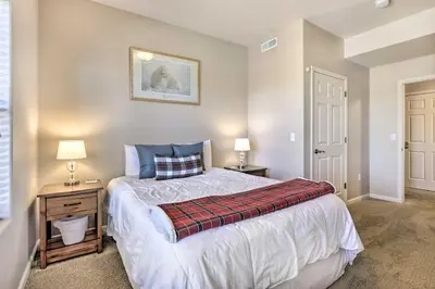 a bedroom with a bed and two night stands with lamps at Spacious Fraser Condo about 6 Mi to Winter Park! in Fraser