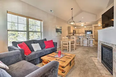 a living room with a couch and a fireplace at Spacious Fraser Condo about 6 Mi to Winter Park! in Fraser