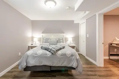a white bedroom with a bed and two lamps at Cottonwood Loveland in Loveland