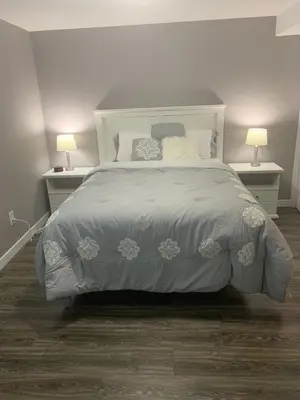 a bedroom with a large bed with two lamps at Cottonwood Loveland in Loveland