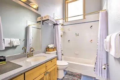 a bathroom with a sink and a toilet and a shower at Secluded Granby Mtn Cabin 75 Acres and Views in Granby