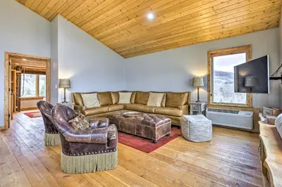 a living room with a couch and a tv at Secluded Granby Mtn Cabin 75 Acres and Views in Granby