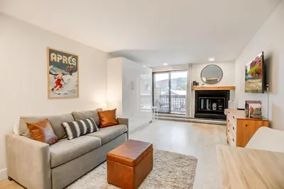 a living room with a couch and a fireplace at Cedar Lodge Royal Studio Condo: Downtown Frisco in Frisco