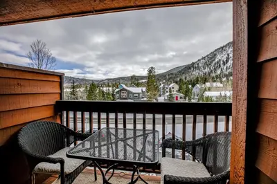 a patio with a table and chairs on a balcony at Cedar Lodge Royal Studio Condo: Downtown Frisco in Frisco