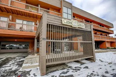 a building with a gate in front of it at Cedar Lodge Royal Studio Condo: Downtown Frisco in Frisco