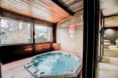 a jacuzzi tub in the middle of a house at Cedar Lodge Royal Studio Condo: Downtown Frisco in Frisco