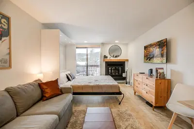 a living room with a couch and a bed at Cedar Lodge Royal Studio Condo: Downtown Frisco in Frisco