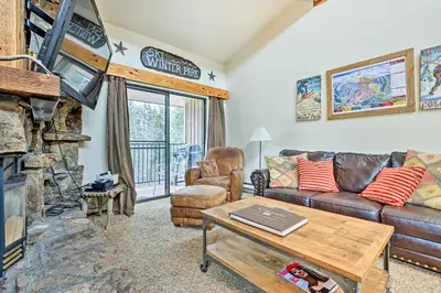 a living room with a couch and a fireplace at Winter Park Condo with Hot Tub, 3 Mi to Slopes! in Winter Park