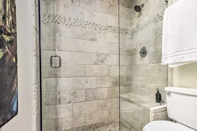 a bathroom with a glass shower with a toilet at Winter Park Condo with Hot Tub, 3 Mi to Slopes! in Winter Park