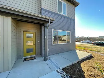 a front door of a house with a yellow door at Hidden Gem - Brand New Curated Home with Pool Access in Fort Collins