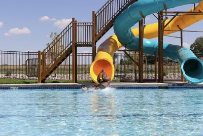 a person in the water at a water park at Hidden Gem - Brand New Curated Home with Pool Access in Fort Collins