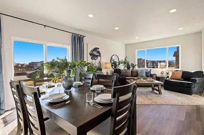 a dining room and living room with a table and chairs at Hidden Gem - Brand New Curated Home with Pool Access in Fort Collins