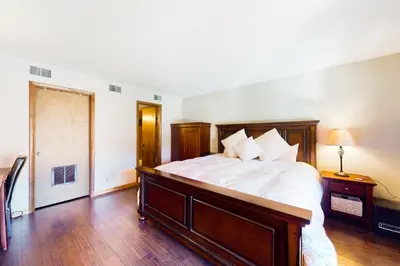 a bedroom with a large bed and a wooden floor at Mountainside Retreat in Frisco