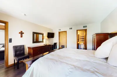 a bedroom with a bed and a desk and a chair at Mountainside Retreat in Frisco