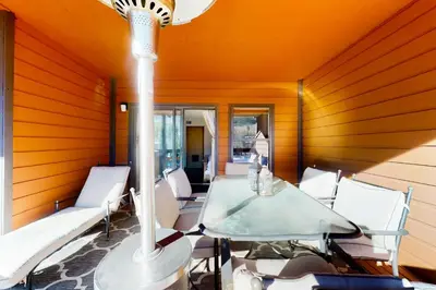 a room with a table and chairs on a porch at Mountainside Retreat in Frisco