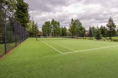 a tennis court with a net on top of it at Mountainside Retreat in Frisco