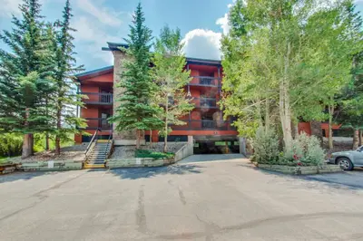 a large red building with trees in front of it at Mountainside Retreat in Frisco