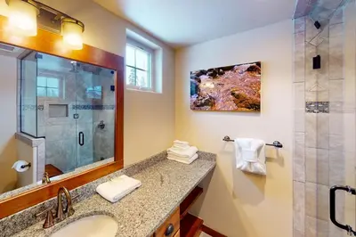 a bathroom with a sink and a shower at Byers Peak Penthouse in Fraser
