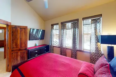 a bedroom with a bed and a flat screen tv at Byers Peak Penthouse in Fraser
