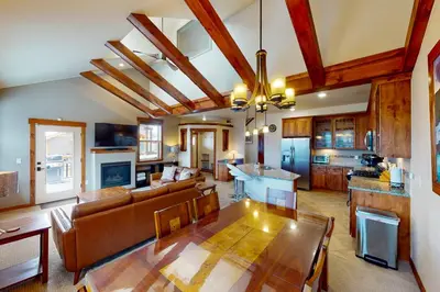 a large living room with a table and a kitchen at Byers Peak Penthouse in Fraser
