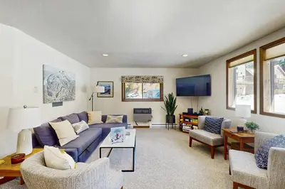 a living room with a blue couch and chairs at Skiing Sanctuary in Winter Park