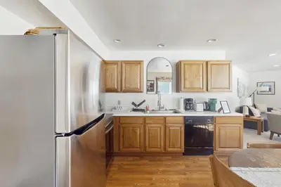 a kitchen with wooden cabinets and a stainless steel refrigerator at Skiing Sanctuary in Winter Park