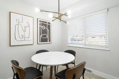a dining room with a white table and chairs at #Marbella Lane - Modern & Spacious 4BR Retreat in Arvada in Arvada