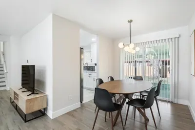 a dining room with a table and chairs and a tv at #Marbella Lane - Modern & Spacious 4BR Retreat in Arvada in Arvada