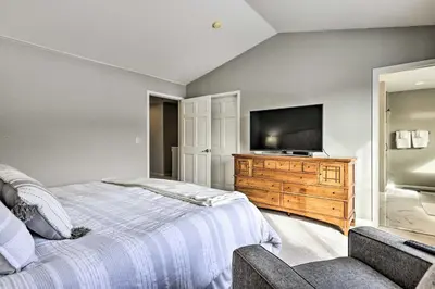 a bedroom with a bed and a flat screen tv at Stunning Mtn Views and Hot Tub Silverthorne Retreat in Silverthorne