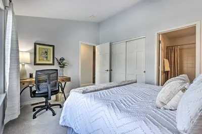 a bedroom with a bed and a desk and a chair at Stunning Mtn Views and Hot Tub Silverthorne Retreat in Silverthorne