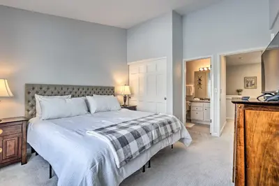 a bedroom with a large bed and a bathroom at Stunning Mtn Views and Hot Tub Silverthorne Retreat in Silverthorne