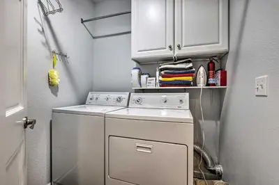 a small laundry room with a white washer and dryer at Stunning Mtn Views and Hot Tub Silverthorne Retreat in Silverthorne
